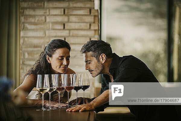 Boyfriend and girlfriend doing wine tasting in restaurant