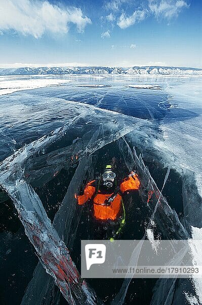 Scuba diver under ice  Lake Baikal  Pribaikalsky National Park  Irkutsk Province  Siberia  Russia  Europe