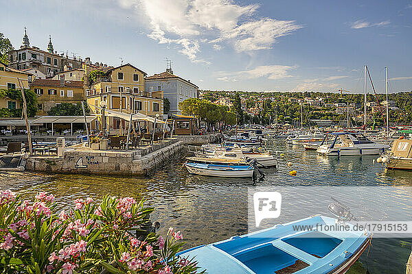 View of boats in the marina and harbourside restaurants during golden hour in Volosko  Opatija  Kvarner Bay  Croatia  Europe