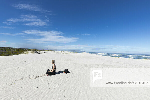 South Africa  Hermanus  Teenage girl (16-17) sitting on Grotto Beach