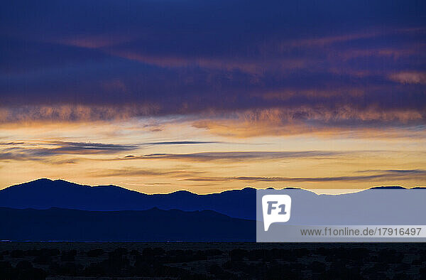 Usa  New Mexico  Santa Fe  Dramatic sunset sky over desert landscape