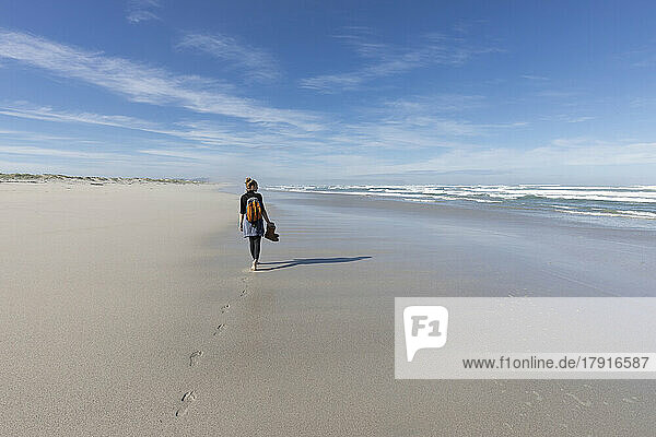 South Africa  Hermanus  Teenage girl (16-17) walking along Grotto Beach