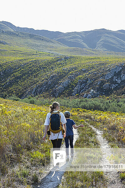 South Africa  Hermanus  Teenage girl (16-17) and brother (8-9) hiking in Phillipskop Nature Reserve