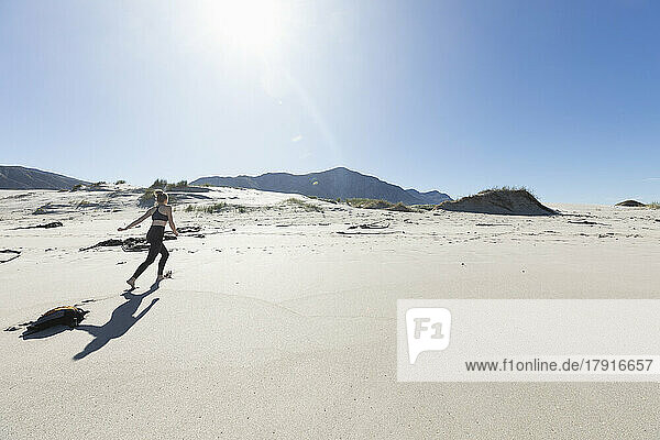South Africa  Hermanus  Teenage girl (16-17) running Grotto Beach