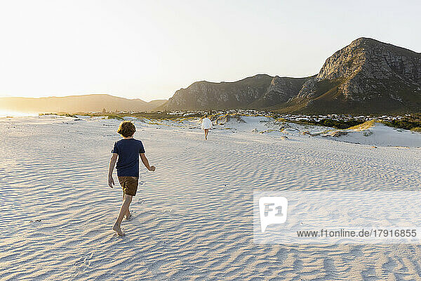 South Africa  Hermanus  Boy (8-9) and girl (16-17) exploring Grotto Beach