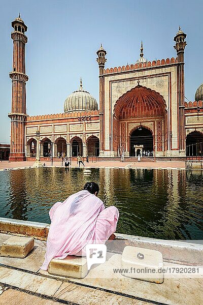 DELHI  INDIA  JUNE 24  2012: Woman in Jama Masjid  the largest mosque in India. Delhi  India  Asia