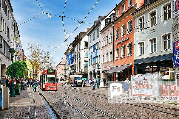 Freiburg  Germany  April 2022: City center with shops and people walking by on sunny spring day  Europe
