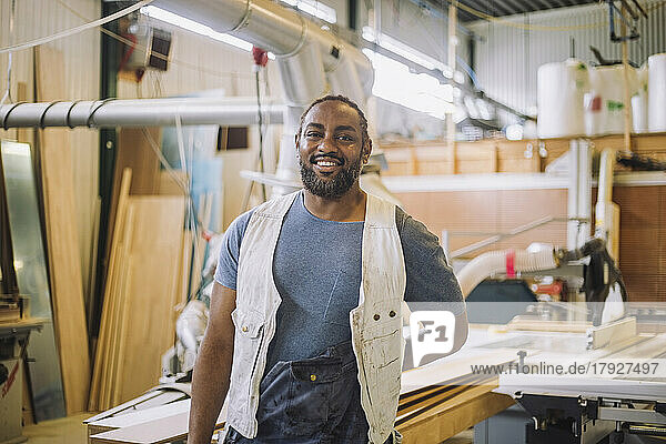 Portrait of happy male carpenter in workshop