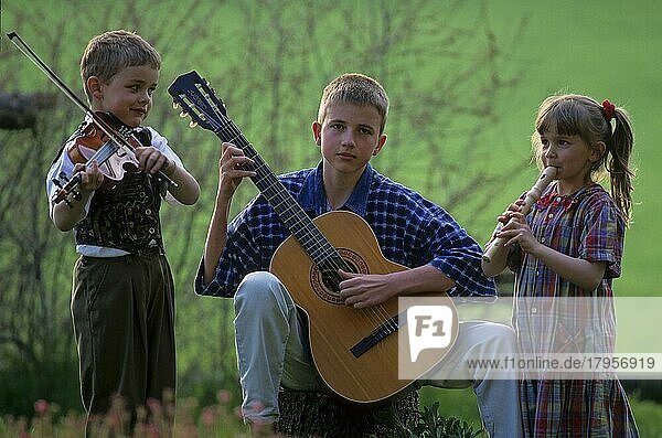 Drei 3 Kinder spielen in der Gruppe Musik  Flöte  Gitarre und Geige  Violine