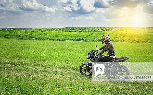 Biker man on a country road  young man on his motorcycle traveling through the countryside  man riding motorcycle in the countryside