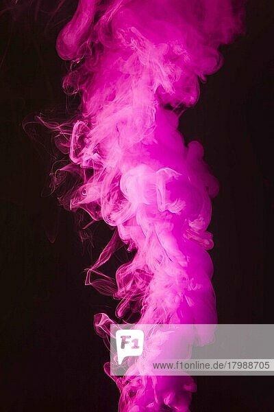 dense fluffy puffs of pink smoke on black background