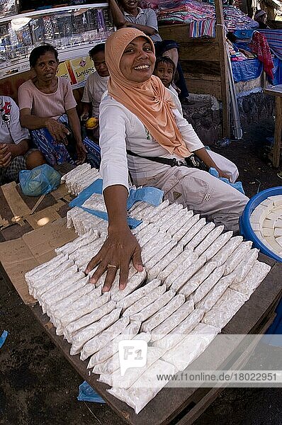 Frau verkauft Sojabohnenprodukte (Tempe und Tofu) auf dem Markt  Kalabahi  Insel Alor  Alor-Archipel  Kleine Sunda-Inseln  Indonesien  Asien