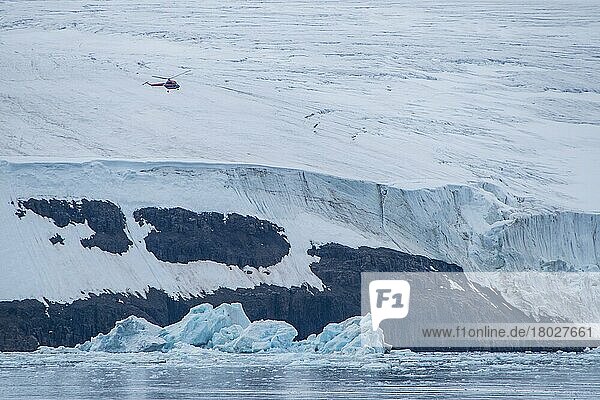 Helicopter flying over the giant icefield of Alexandra Land  Franz Josef Land archipelago  Russia  Europe