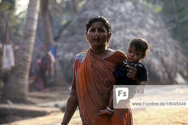 Fisher woman carrying her child at hip  Vishakapatnam Vizag  Andhra Pradesh  India  Asia