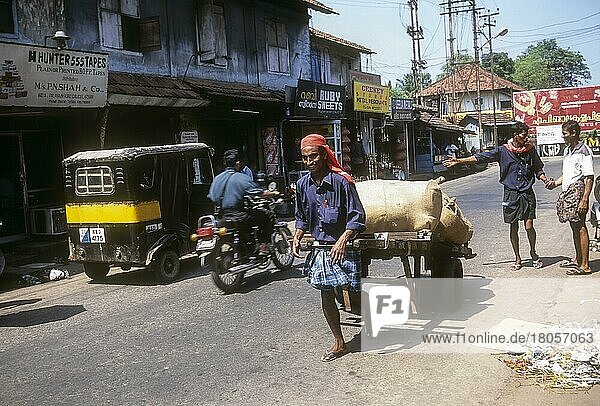 Coolie Pulling the hand cart at Kozhikode  Calicut  Kerala  India  Asia