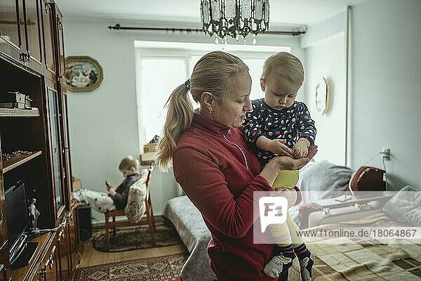 A mother with her youngest daughter  her man and her eldest are at the front  they fled from Lviv to the family's home village  Pavliv  Ukraine  Europe