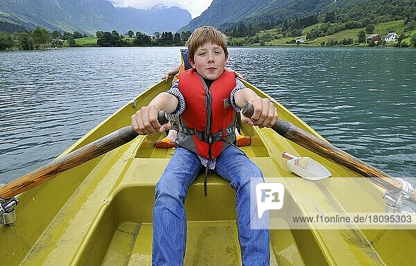 Boy in rowing boat  Flon  Flonsee  lake  Flönsee  Flön near Olden  Sogn og Fjordane  Norway  Europe