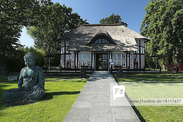 Thatched roof house Mikado Garden with Buddha rope  Timmendorfer Strand  Ostholstein  Schleswig-Holstein  Germany  Europe