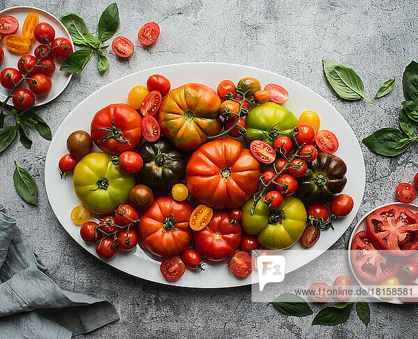 Top view of platter of colorful heirloom and cherry tomatoes.