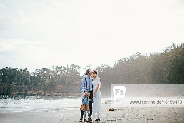 Elopement family running on the beach together during sunset in