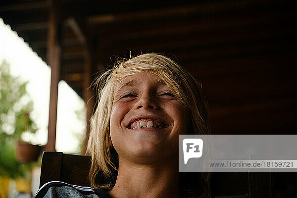 Portrait of a cute caucasian boy laughing outdoors