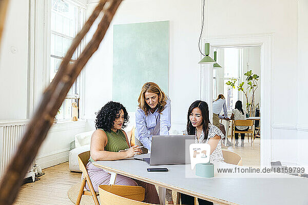 Multiracial businesswomen planning business strategy over laptop