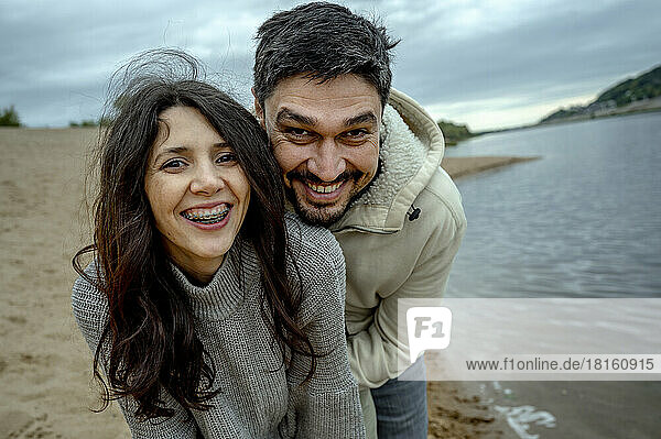 Happy couple having fun at riverbank