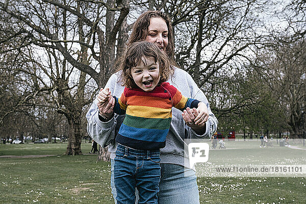 Mother playing with daughter in park