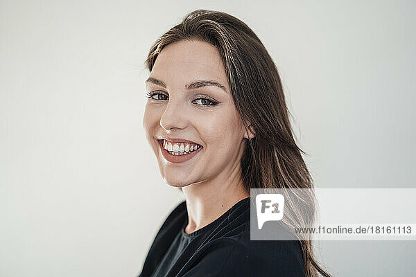 Happy young woman with brown hair against white background