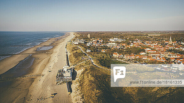 Aerial view of beach by city on sunny day