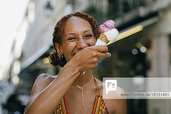 Cheerful young woman enjoying ice cream