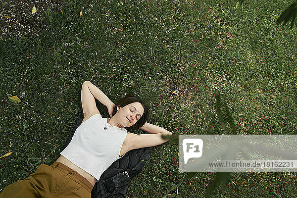 Woman with eyes closed relaxing in garden