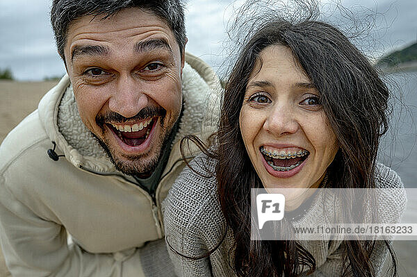 Cheerful man and woman having fun together on weekend