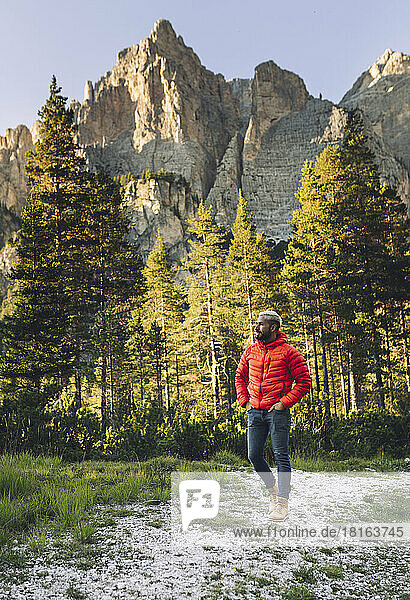 Hiker walking in front of Dolomites  Italy