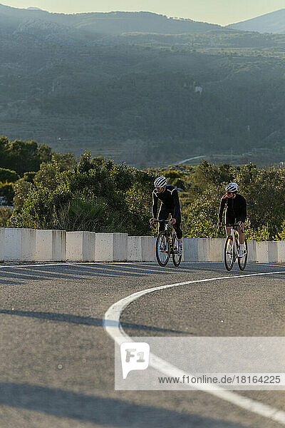 Cyclists moving up on Costa Blanca mountain pass in Alicante  Spain