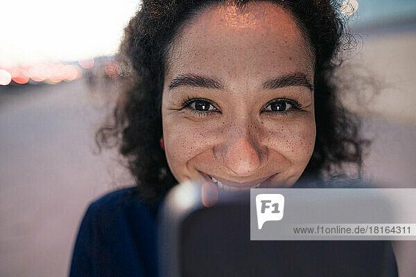 Smiling businesswoman with mobile phone
