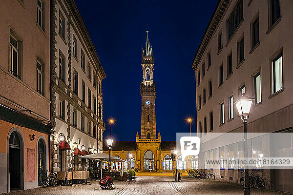 Germany  Baden-Wurttemberg  Konstanz  Illuminated street at night with facade of Konstanz Station in background
