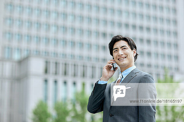 Japanese businessman talking on smartphone