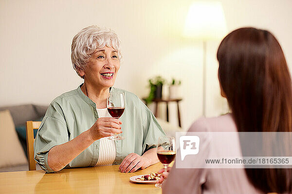 Japanese senior and young women enjoying wine at home