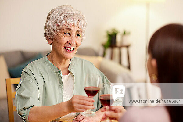 Japanese senior and young women enjoying wine at home