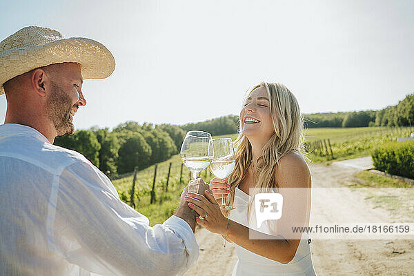 Happy couple having fun with wine glass at winery