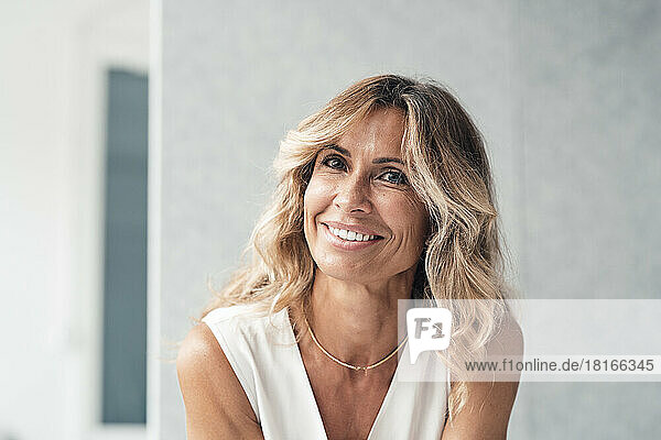 Happy businesswoman with blond hair at office