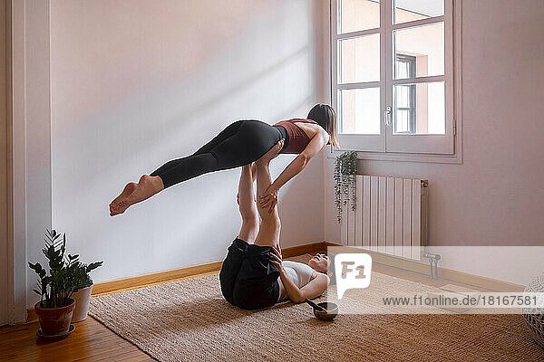 Women doing acroyoga at home