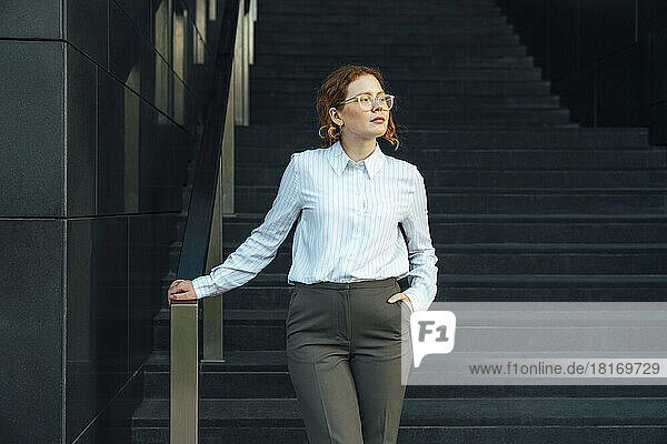 Confident young businesswoman with hand in pocket