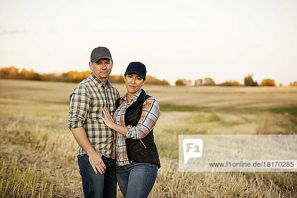 A husband and wife spending some quality time together after accomplishing their fall canola harvest; Alcomdale  Alberta  Canada