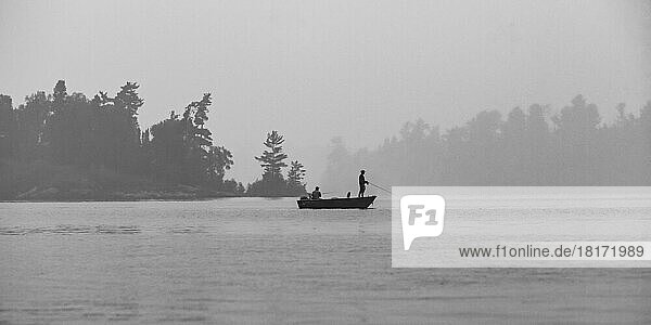 Boating and fishing on a lake with fog  Lake of the Woods  Ontario; Kenora  Ontario  Canada