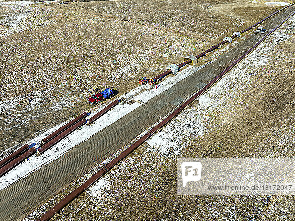 Aerial view of pipeline construction in a snow-covered field  West of Calgary; Alberta  Canada