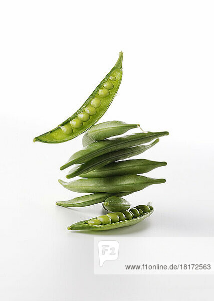Stack of Raw Pea Pods on White Background