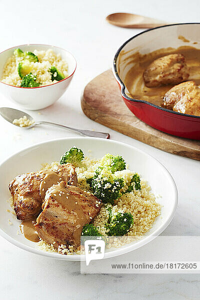 Chicken thighs with mustard sauce served with couscous and broccoli