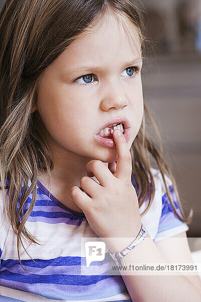 Close-up of Girl Playing with Loose Tooth